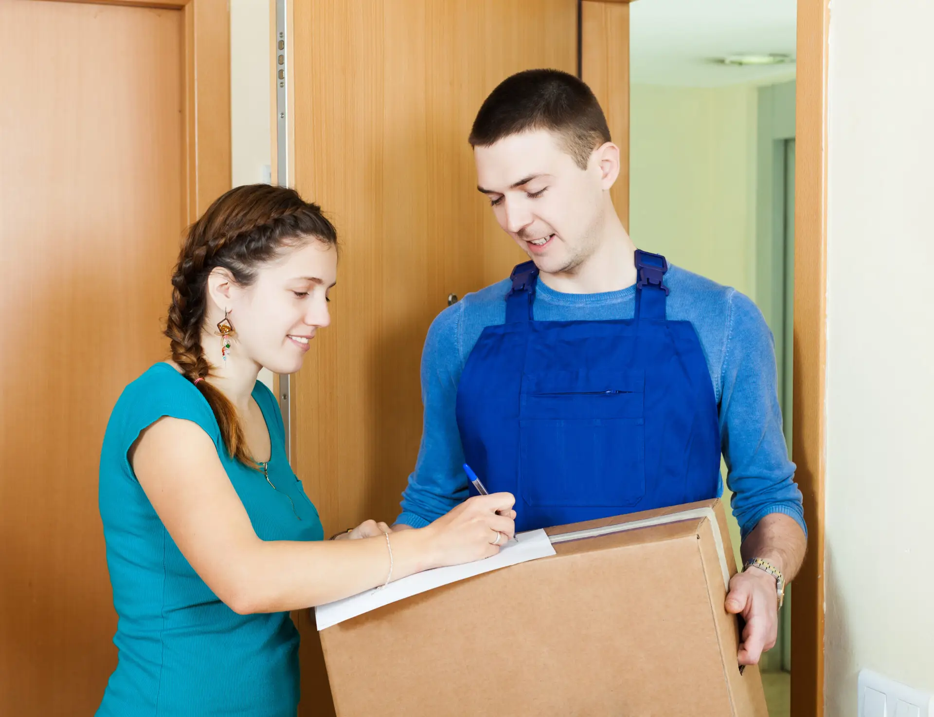 postman in uniform delivered parcel to girl